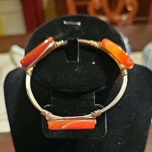 Handcrafted wire-wrapped bangle cuff bracelet featuring red agate Stone Gold